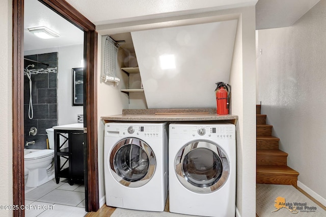 3091 N Longspur Dr, Wasilla, AK 99654 - laundry room featuring washer and dryer and light tile patterned flooring