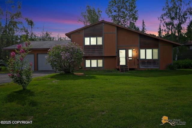 3091 N Longspur Dr, Wasilla, AK 99654 - split level home with asphalt driveway, a front yard, and an attached garage