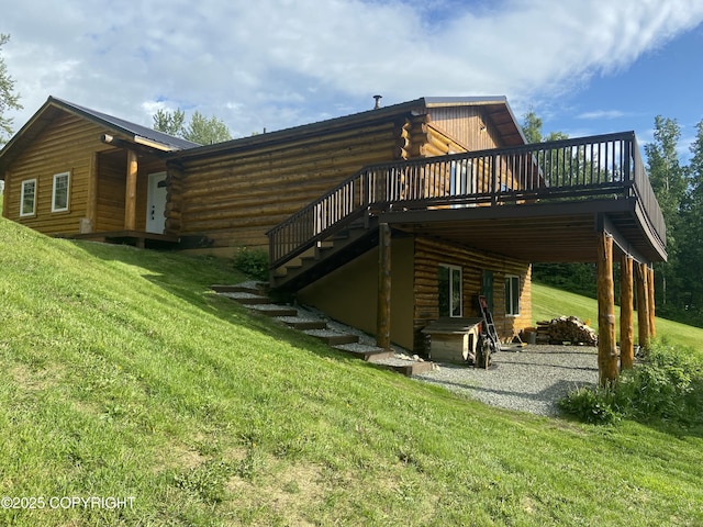 4600 N Slumber Dr, Palmer, AK 99645 - back of property featuring log exterior, a wooden deck, a lawn, and stairway