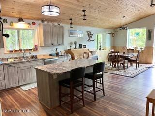 18905 Langille Rd, Cooper Landing, AK 99572 - kitchen with dark wood finished floors, wooden ceiling, pendant lighting, lofted ceiling, and a center island