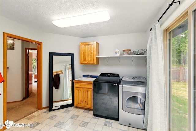 51137 Nanook Cir, Nikiski/North Kenai, AK 99611 - washroom with cabinet space, washer and clothes dryer, light flooring, a textured ceiling, and baseboards