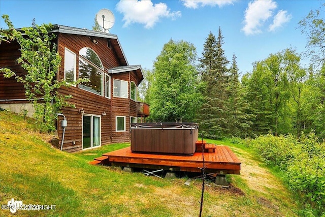51137 Nanook Cir, Nikiski/North Kenai, AK 99611 - back of property with a hot tub, a wooden deck, and a lawn