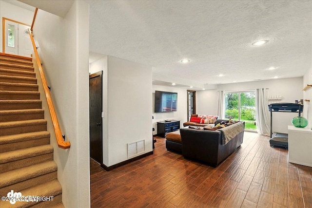 51137 Nanook Cir, Nikiski/North Kenai, AK 99611 - living room featuring dark wood-style floors, stairs, a textured ceiling, and recessed lighting