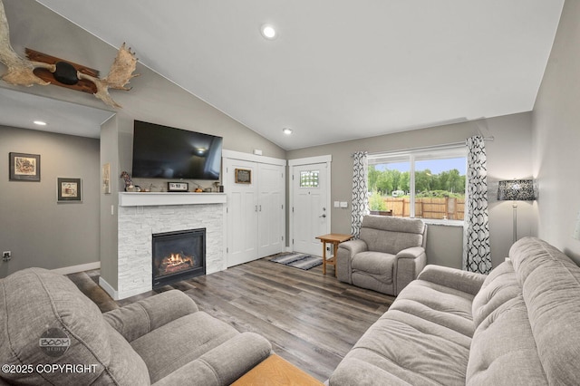 1169 W Trumpeter Swan Dr, Wasilla, AK 99623 - living room with a fireplace, wood finished floors, recessed lighting, high vaulted ceiling, and baseboards