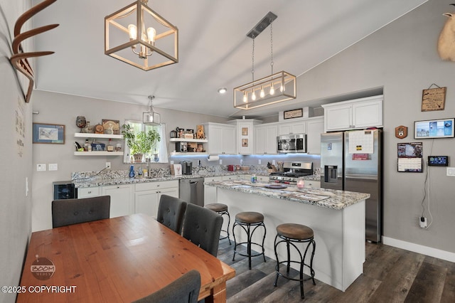 1169 W Trumpeter Swan Dr, Wasilla, AK 99623 - kitchen with appliances with stainless steel finishes, open shelves, a chandelier, white cabinetry, and dark wood finished floors