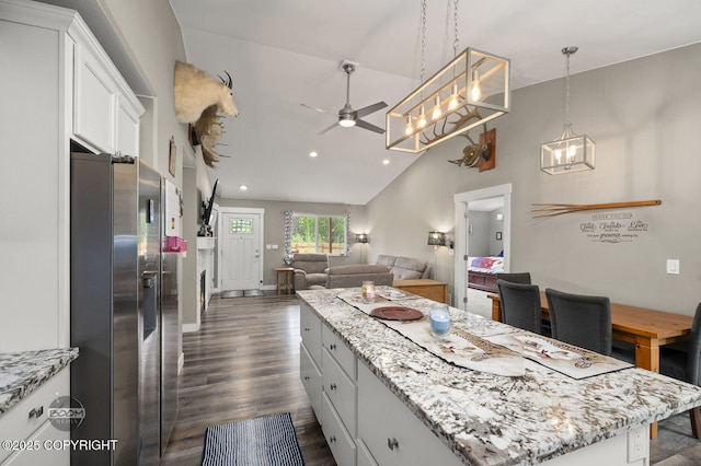 1169 W Trumpeter Swan Dr, Wasilla, AK 99623 - kitchen featuring stainless steel refrigerator with ice dispenser, vaulted ceiling, open floor plan, ceiling fan, and a kitchen island