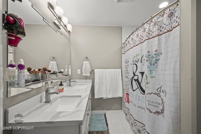 1169 W Trumpeter Swan Dr, Wasilla, AK 99623 - full bathroom with double vanity, curtained shower, and wood finished floors