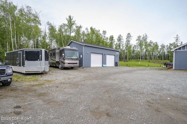 1169 W Trumpeter Swan Dr, Wasilla, AK 99623 - detached garage featuring view of wooded area