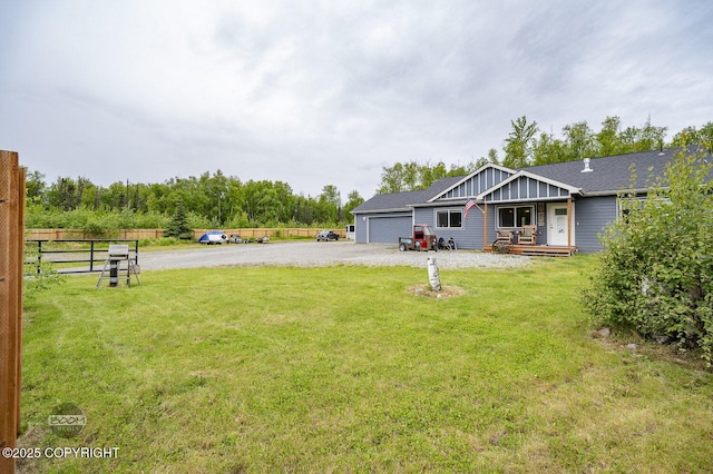 1169 W Trumpeter Swan Dr, Wasilla, AK 99623 - view of yard featuring a garage and driveway