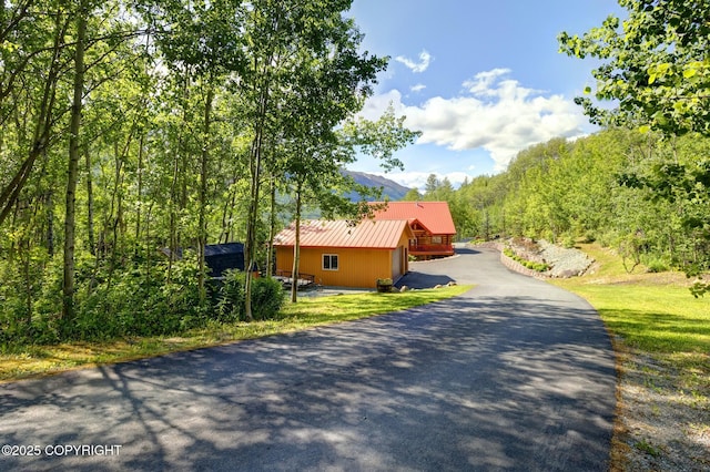3108 Misty Mountain Rd, Eagle River, AK 99577 - view of property exterior featuring driveway and a metal roof