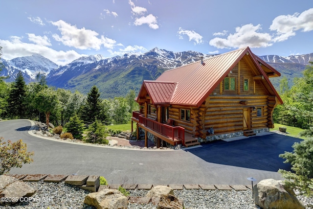3108 Misty Mountain Rd, Eagle River, AK 99577 - view of front of home with log siding, a standing seam roof, a metal roof, and a deck with mountain view