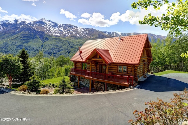 3108 Misty Mountain Rd, Eagle River, AK 99577 - log-style house with log exterior, a standing seam roof, a metal roof, and a deck with mountain view