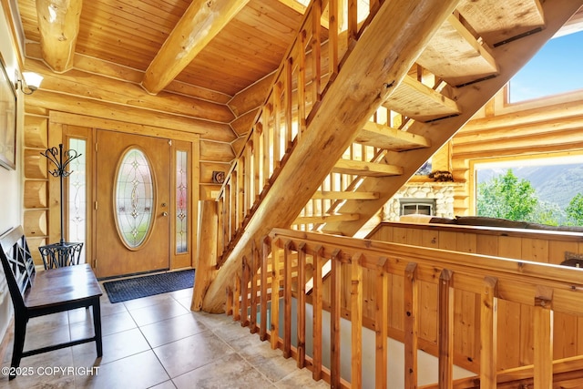 3108 Misty Mountain Rd, Eagle River, AK 99577 - tiled foyer entrance featuring log walls, stairs, and a wooden ceiling with exposed beams