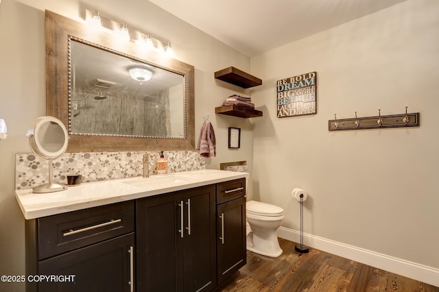 3108 Misty Mountain Rd, Eagle River, AK 99577 - bathroom featuring tasteful backsplash, vanity, tiled shower, and wood finished floors