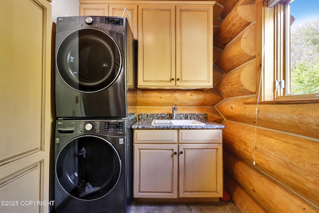 3108 Misty Mountain Rd, Eagle River, AK 99577 - laundry area featuring stacked washer and clothes dryer, cabinet space, and log walls