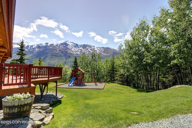 3108 Misty Mountain Rd, Eagle River, AK 99577 - view of green lawn with a playground and a deck with mountain view