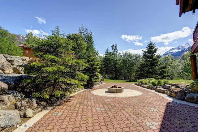 3108 Misty Mountain Rd, Eagle River, AK 99577 - view of patio / terrace featuring an outdoor fire pit and a mountain view
