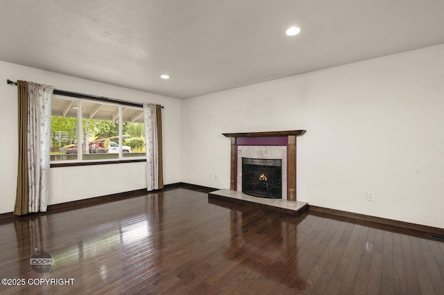 10010 Colville St, Eagle River, AK 99577 - unfurnished living room featuring a fireplace, hardwood / wood-style flooring, and recessed lighting