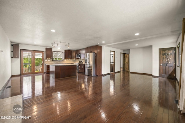 10010 Colville St, Eagle River, AK 99577 - unfurnished living room featuring dark wood finished floors, recessed lighting, and a textured ceiling