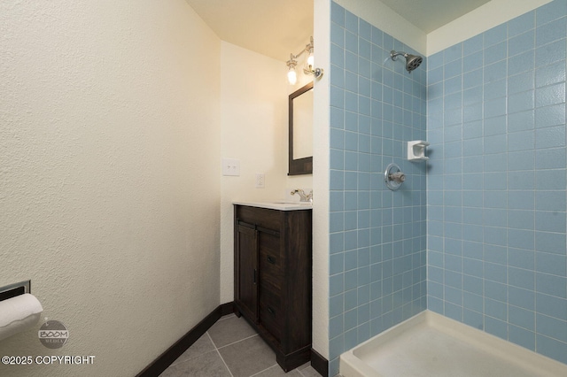 10010 Colville St, Eagle River, AK 99577 - bathroom with tiled shower, tile patterned flooring, and vanity