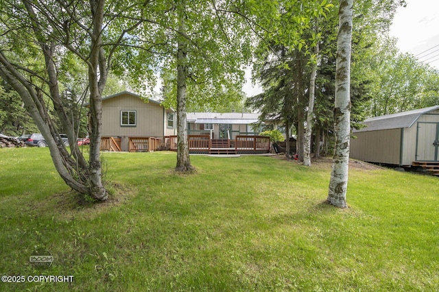 10010 Colville St, Eagle River, AK 99577 - view of grassy yard featuring a wooden deck and a shed
