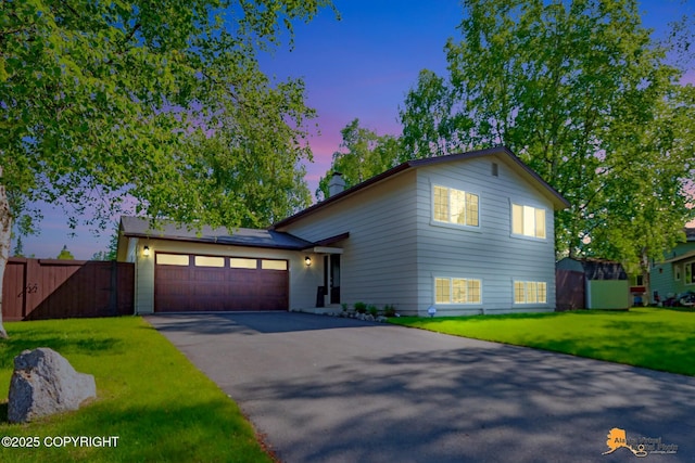 2309 Success Dr, Anchorage, AK 99504 - split level home featuring driveway, an attached garage, a chimney, and a gate