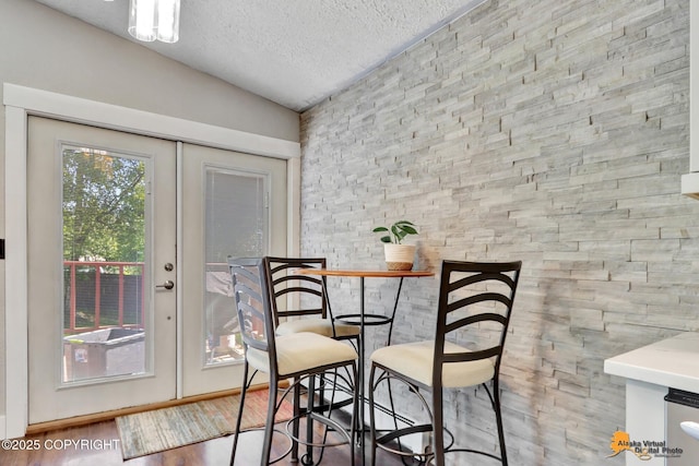 2309 Success Dr, Anchorage, AK 99504 - dining space with healthy amount of natural light, a textured ceiling, and wood finished floors