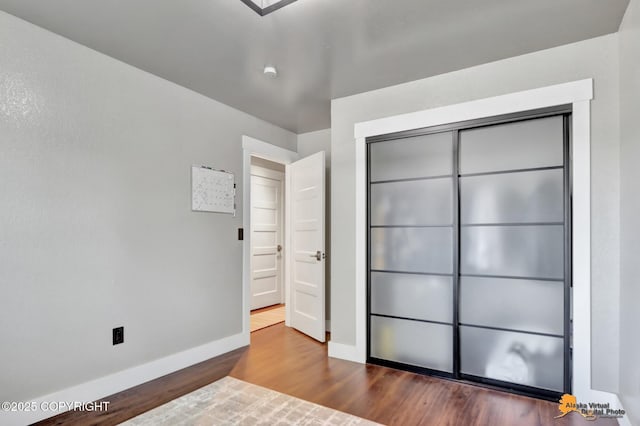 2309 Success Dr, Anchorage, AK 99504 - unfurnished bedroom with dark wood-style flooring and a closet