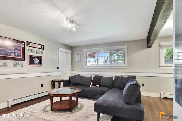 2309 Success Dr, Anchorage, AK 99504 - living room featuring a baseboard heating unit, wood finished floors, a textured ceiling, and rail lighting