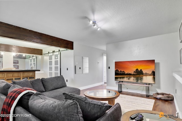 2309 Success Dr, Anchorage, AK 99504 - living room featuring wood finished floors, electric panel, a barn door, and a textured ceiling