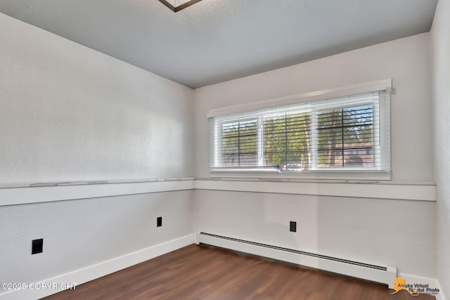 2309 Success Dr, Anchorage, AK 99504 - spare room with a baseboard heating unit and dark wood-style flooring