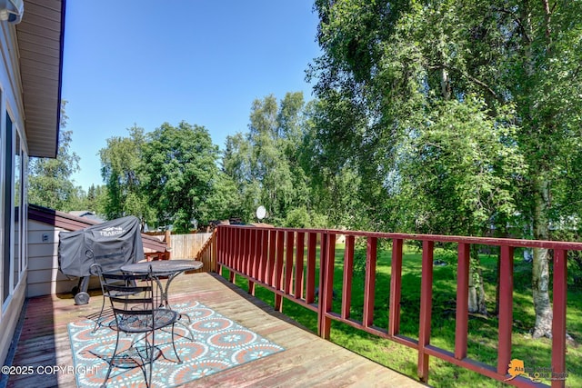 2309 Success Dr, Anchorage, AK 99504 - wooden terrace with grilling area, a lawn, and view of scattered trees