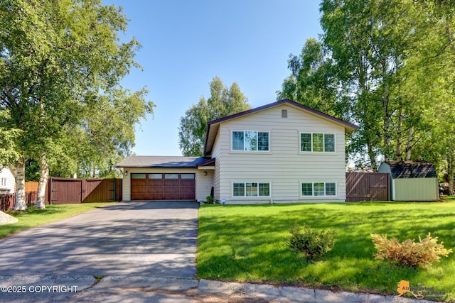 2309 Success Dr, Anchorage, AK 99504 - tri-level home with driveway, a gate, an attached garage, and a shed