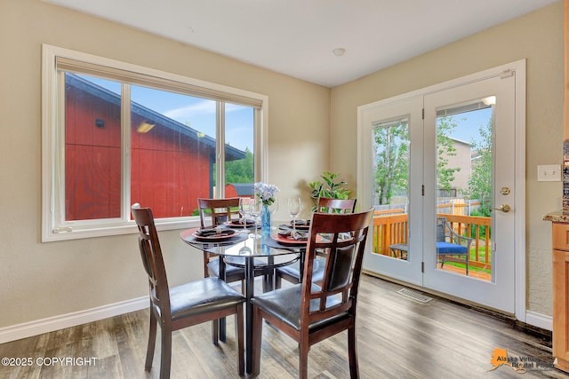 8630 E 17th Ave, Anchorage, AK 99504 - dining area featuring healthy amount of natural light and wood finished floors