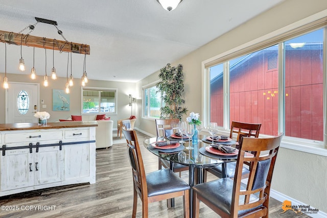 8630 E 17th Ave, Anchorage, AK 99504 - dining area featuring plenty of natural light and wood finished floors