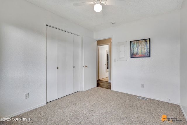 8630 E 17th Ave, Anchorage, AK 99504 - unfurnished bedroom featuring carpet, a closet, a textured ceiling, and ceiling fan