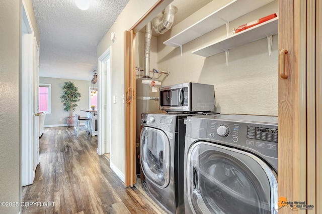 8630 E 17th Ave, Anchorage, AK 99504 - washroom with wood finished floors, independent washer and dryer, a textured ceiling, and a textured wall