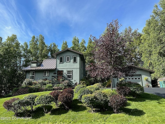 21212 Rock Ptarmigan St, Chugiak, AK 99567 - view of front facade with a standing seam roof, a metal roof, a front lawn, a garage, and asphalt driveway