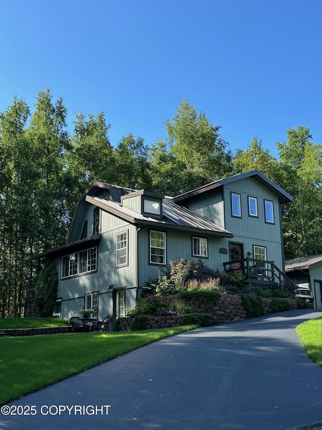 21212 Rock Ptarmigan St, Chugiak, AK 99567 - view of front facade with a front lawn and a garage