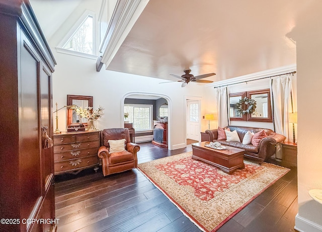 21212 Rock Ptarmigan St, Chugiak, AK 99567 - living area featuring arched walkways, dark wood finished floors, and a ceiling fan