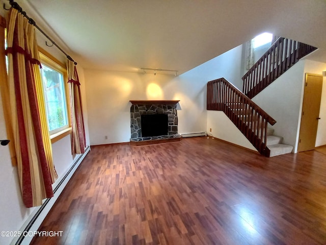 17701 Beaujolais Dr, Eagle River, AK 99577 - unfurnished living room with baseboard heating, wood finished floors, track lighting, and stairway