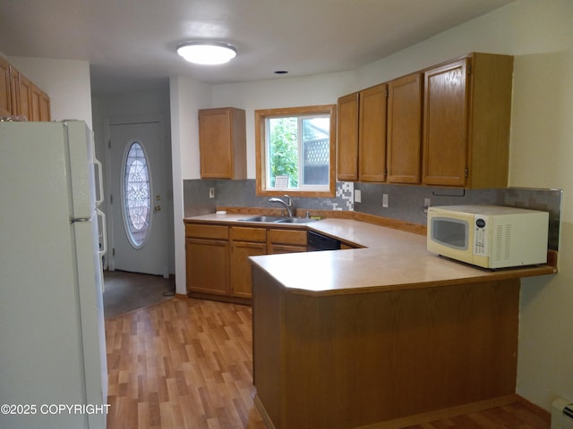 17701 Beaujolais Dr, Eagle River, AK 99577 - kitchen featuring white appliances, a peninsula, light wood-type flooring, light countertops, and brown cabinetry