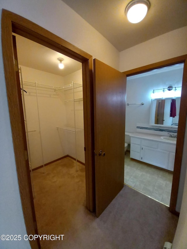 17701 Beaujolais Dr, Eagle River, AK 99577 - hallway featuring a sink and carpet floors