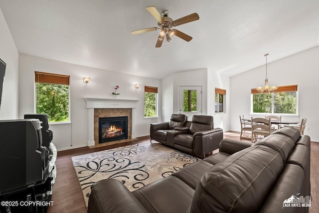7595 E Breckenridge Dr, Wasilla, AK 99654 - living room with lofted ceiling, healthy amount of natural light, a fireplace, ceiling fan, and a textured ceiling