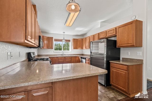 7595 E Breckenridge Dr, Wasilla, AK 99654 - kitchen with appliances with stainless steel finishes, a peninsula, brown cabinets, light countertops, and vaulted ceiling
