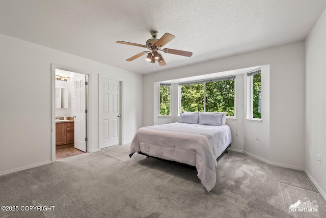7595 E Breckenridge Dr, Wasilla, AK 99654 - bedroom featuring light colored carpet, a textured ceiling, ensuite bath, and a ceiling fan