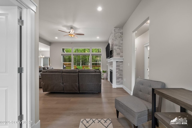 8028 E Yarn Spinner Cir, Palmer, AK 99645 - living area with ceiling fan, a fireplace, wood finished floors, and recessed lighting