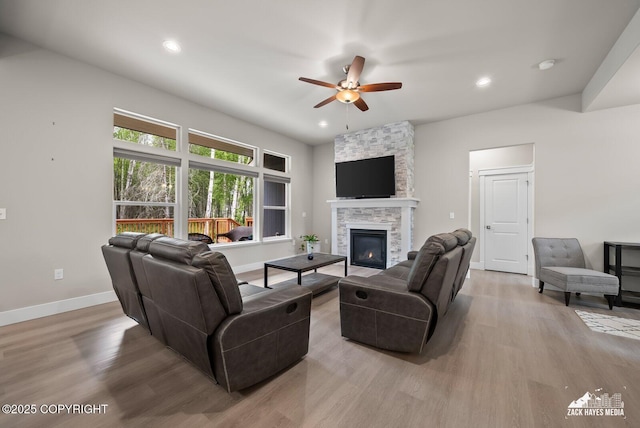 8028 E Yarn Spinner Cir, Palmer, AK 99645 - living room featuring a ceiling fan, wood finished floors, a stone fireplace, and recessed lighting