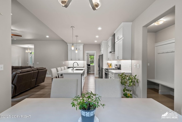 8028 E Yarn Spinner Cir, Palmer, AK 99645 - dining area featuring wood finished floors, recessed lighting, and a chandelier