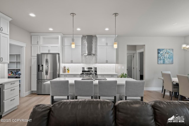 8028 E Yarn Spinner Cir, Palmer, AK 99645 - kitchen featuring stainless steel appliances, wall chimney exhaust hood, light countertops, open floor plan, and recessed lighting
